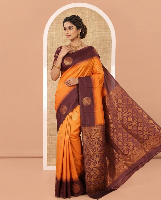 Rust Orange Art Soft Silk Saree, Subtly Sparkled with Zari Buttas All Over Its Body,  Complemented by a Contrast Chakram Motifs Border, an Intricately Designed Pallu, and Paired with a Contrast Blouse
