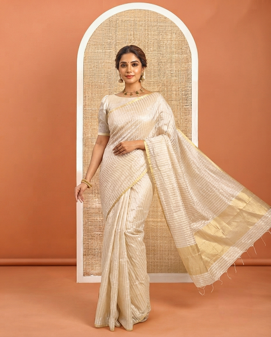 Borderless Off-white Tissue Saree, Richly Detailed with Vertical Golden Zari Stripes All Over Its Body, Highlighted by Gleaming Zari Striped Pallu, and Paired with a Matching Blouse