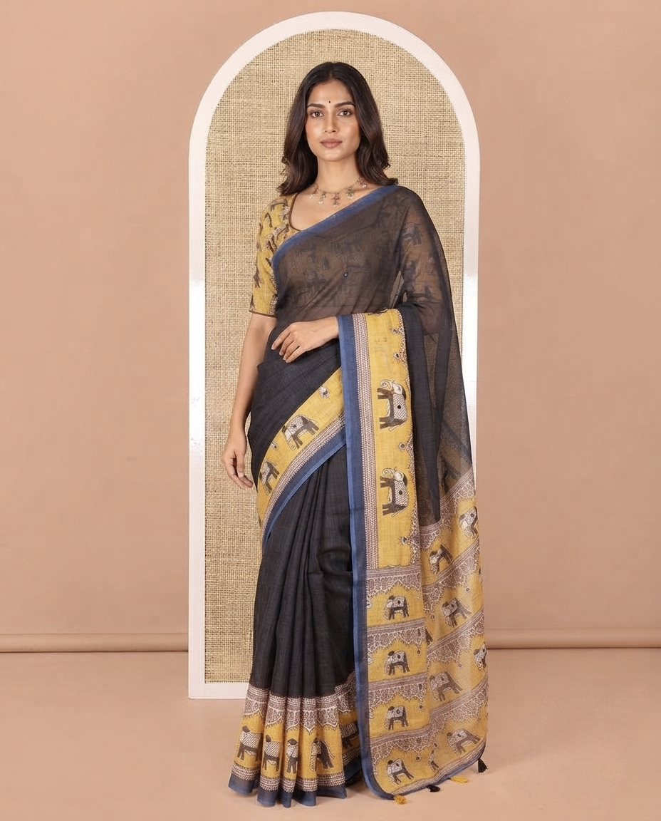 Black Linen Cotton Saree, Gleamed up with Mirror Work On Its Body, Complemented by Contrast Elephant Motifs Printed Border, Pallu Steeped with Elephant Motifs Print, and Paired with a Contrast Blouse