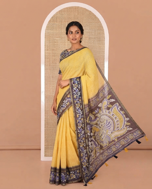 Yellow Linen Cotton Saree, Subtly Printed With Checked Design On Its Body, Complemented by Contrast Border of Kalamkari-Style Floral Vine Print, Pallu of Kalamkari Peacock Print, and Paired with a Contrast Blouse