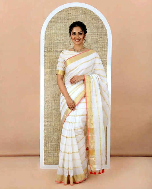 Cream Khadi Mul Cotton Saree, Gleamed up with Zari Stripes All Over Its Body, Subtle Gold Zari Border, Self-Pallu with Tassels, and Paired with a Matching Blouse