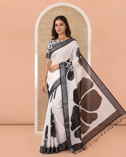 White Linen Cotton Saree, Adorned with Big Floral Prints On Its Body, Complemented by Contrast Zari Bavanji Border, Floral Printed Pallu, and Paired with a Hand Block Printed Blouse