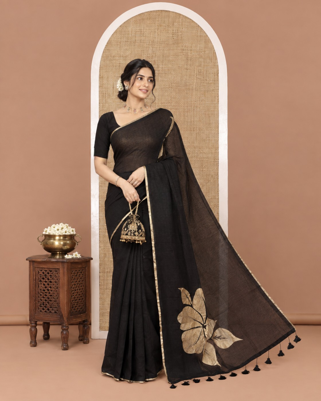 Borderless Black Khadi Mul Cotton Saree, Prettified with Big Hibiscus Floral Motifs Foil-Printed on Its Body, Subtly Sparkled Pallu of the Same Print and Tassels, and Paired with a Matching Blouse