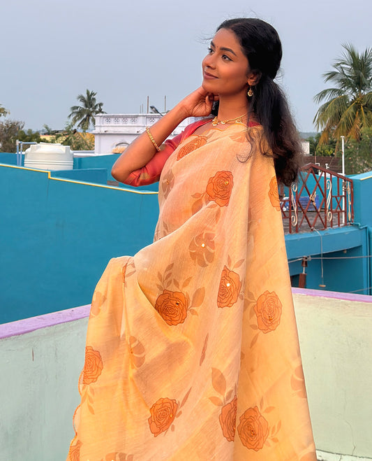 Gold and yellow rose motifs printed with mirror work tissue saree, scallop embroidered border, printed pallu, and a contrast blouse