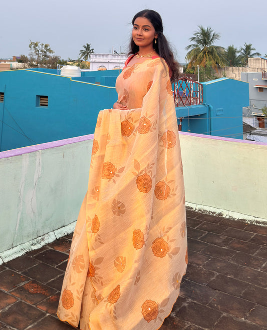 Gold and yellow rose motifs printed with mirror work tissue saree, scallop embroidered border, printed pallu, and a contrast blouse