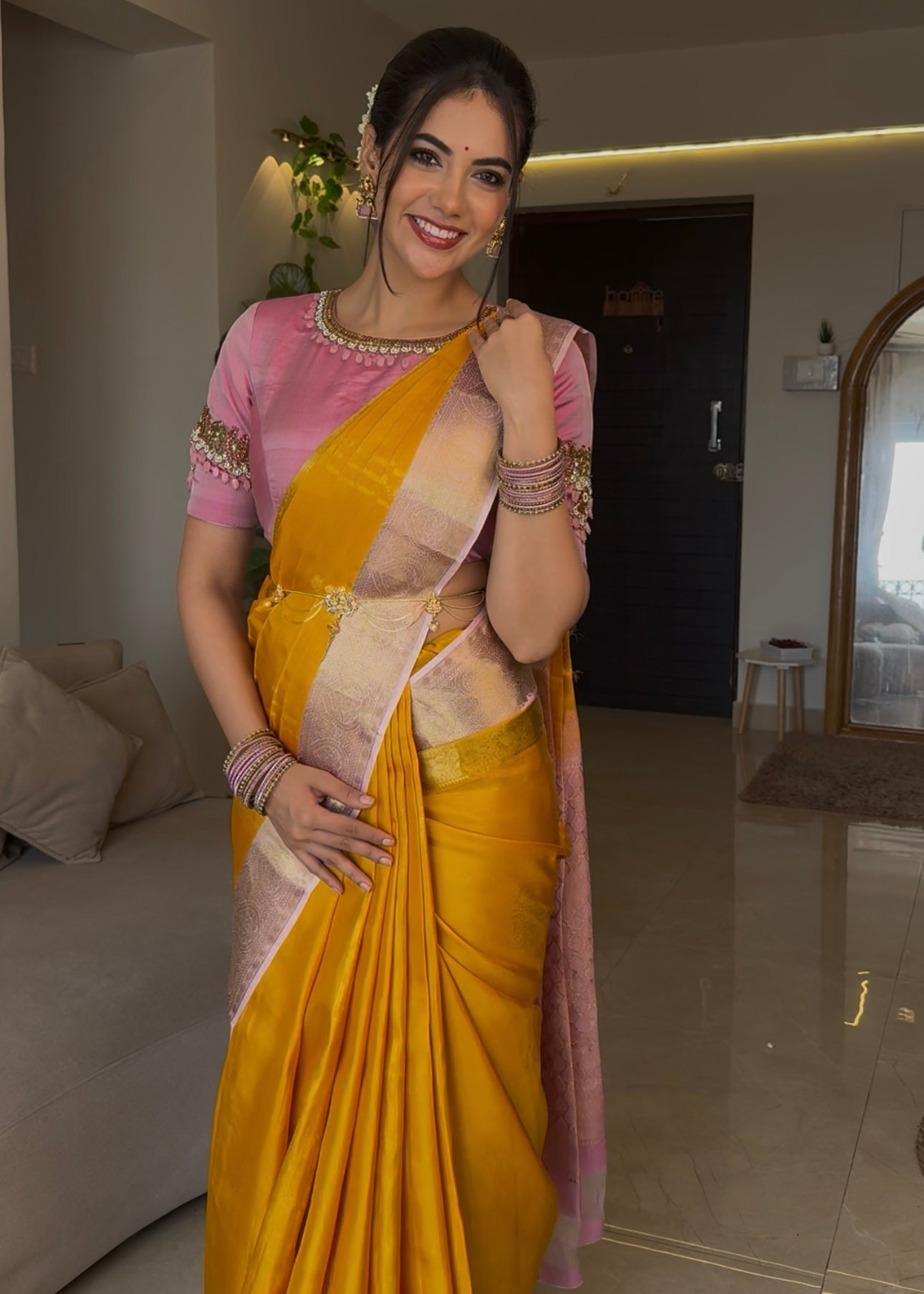 Mustard Yellow-Beach Pink Vasundhara Silk Saree Features Zari Buttas, Contrast Border of Cross Kamalam, Rudraksham, and Thilakam, Grand Pallu, and a Contrast Blouse