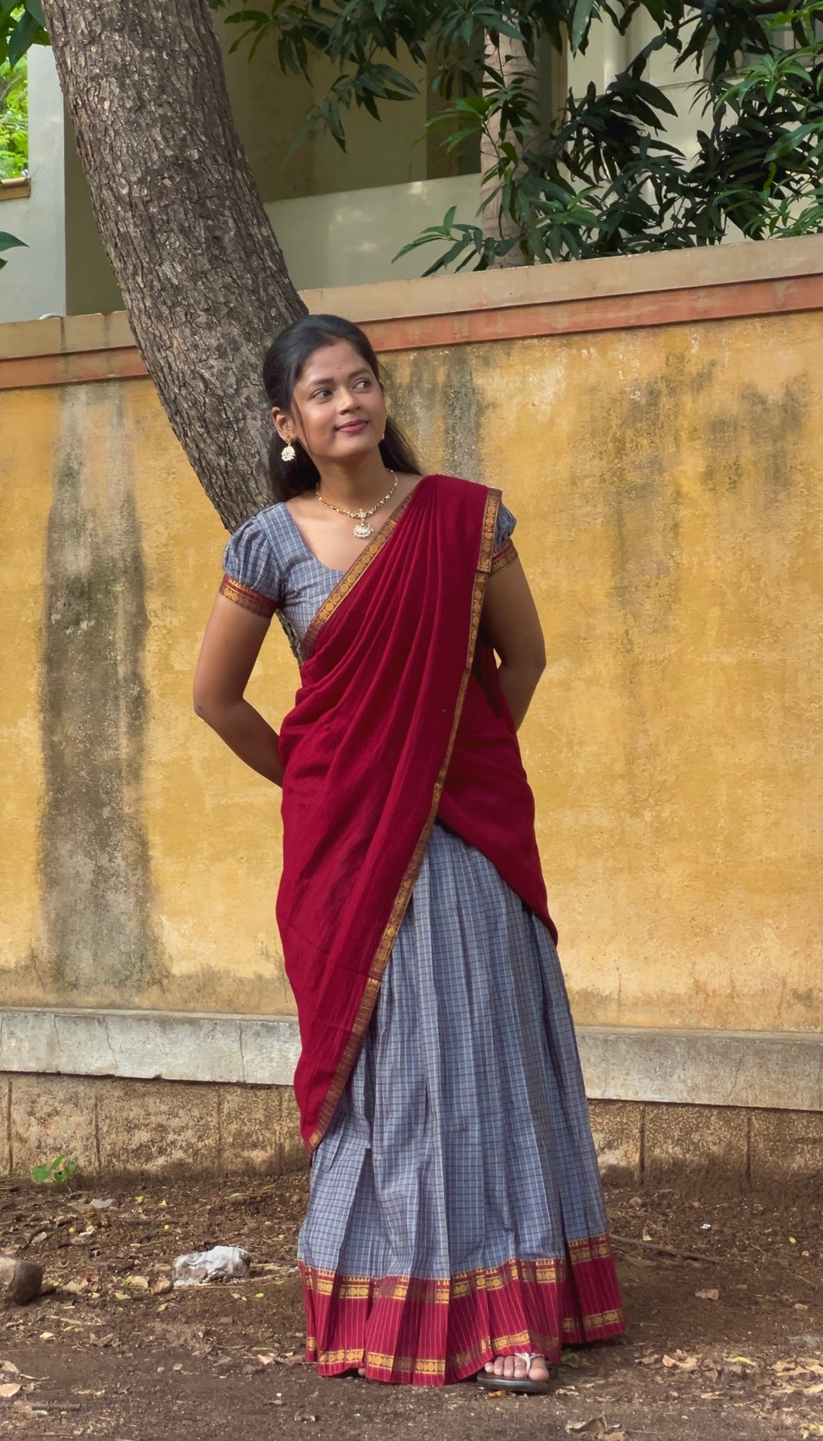 Grey and Red Sungudi Cotton Half-Saree, Elevated with Checked Design with Contrast Traditional Design Rettai Pettu Bordered Skirt, Comes with a Matching Blouse, and Is Paired with a Contrast Dhavani