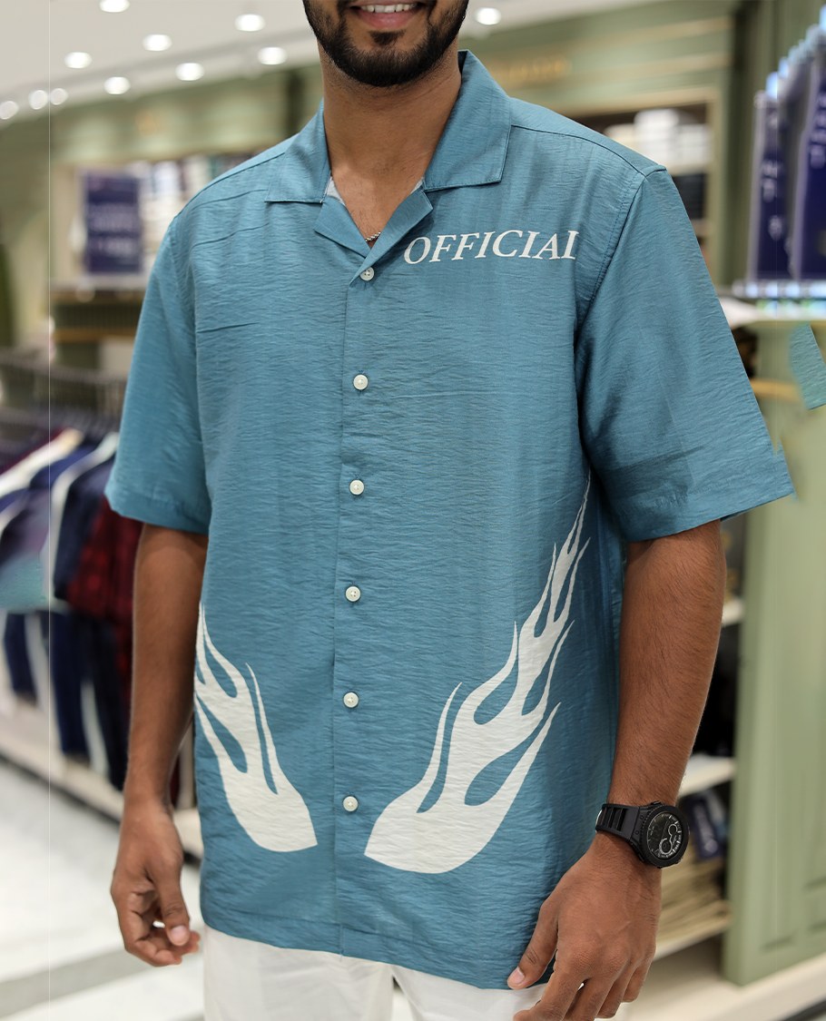 Blue Poly-Blended Causal Shirt, Comes with Fire Motifs Print, Half Sleeves, a Cuban Collar, a Boxy Fit, and Regular Length