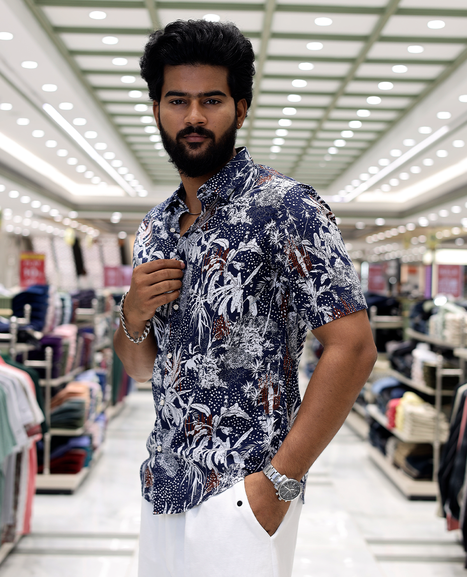 Blue Cotton-Blended Casual Shirt, Decked Up with Tropical Floral Print, Half Sleeves, a Regular Fit, a Spread Collar, and Regular Length