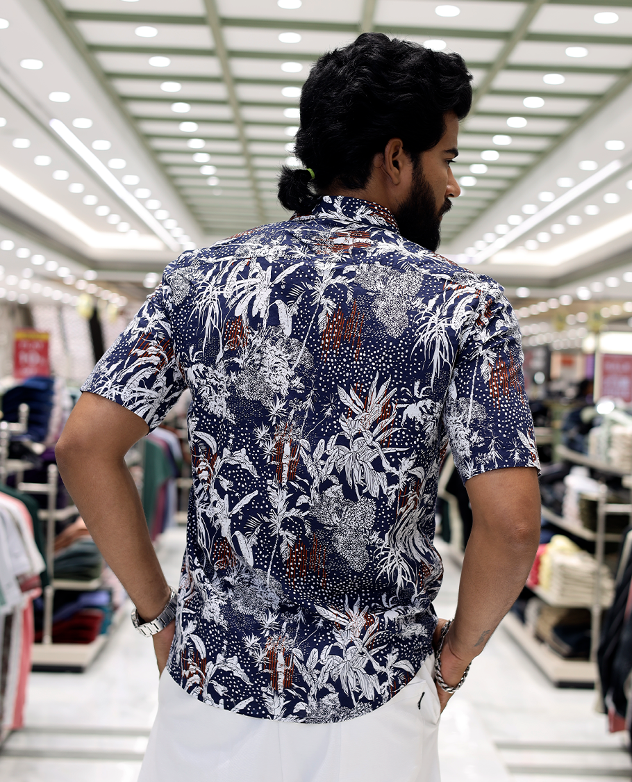 Blue Cotton-Blended Casual Shirt, Decked Up with Tropical Floral Print, Half Sleeves, a Regular Fit, a Spread Collar, and Regular Length