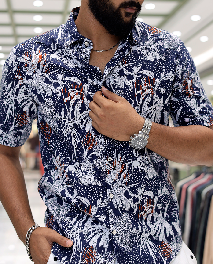 Blue Cotton-Blended Casual Shirt, Decked Up with Tropical Floral Print, Half Sleeves, a Regular Fit, a Spread Collar, and Regular Length