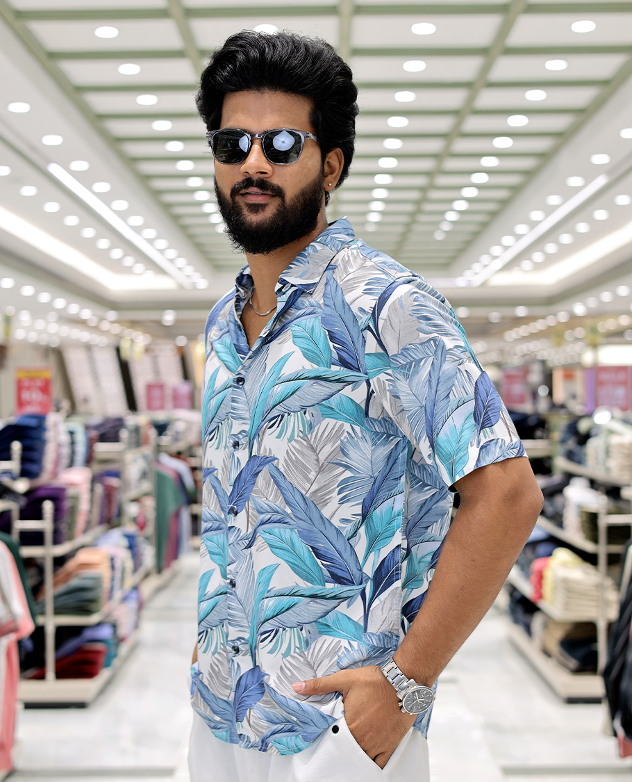 Blue Cotton-Blended Casual Shirt, Elevated with Tropical Floral Print, Half Sleeves, a Regular Fit, a Spread Collar, and Regular Length