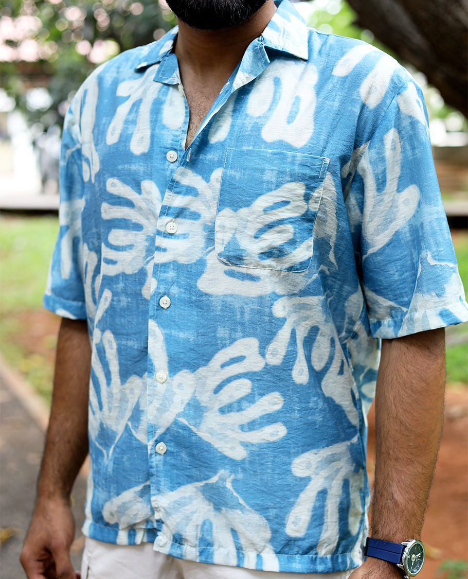 Blue Cotton-Blended Casual Shirt features an Abstract Print, Half Sleeves, Cuban Collar, Regular Fit, and Regular Length