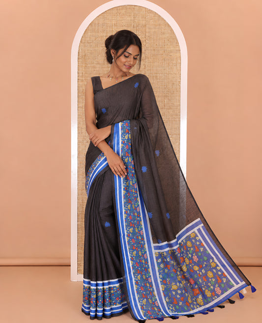 Black floral motifs printed linen cotton saree with contrast kalamkari floral vine printed border, floral vine printed pallu, and a plain blouse
