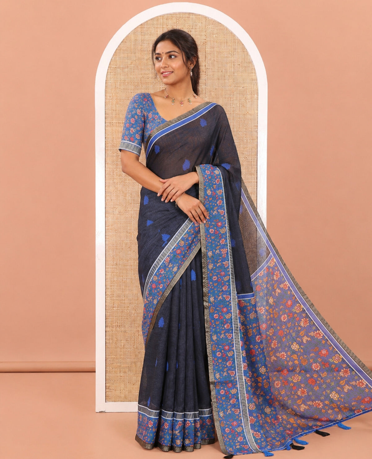 Black Linen Saree Adorned with Leaf Motifs All Over Its Body, Complemented by a Contrast Floral Vine Printed Border, Pallu Mirrors the Floral Vine Print, and Paired with a  Contrast Floral Printed Blouse