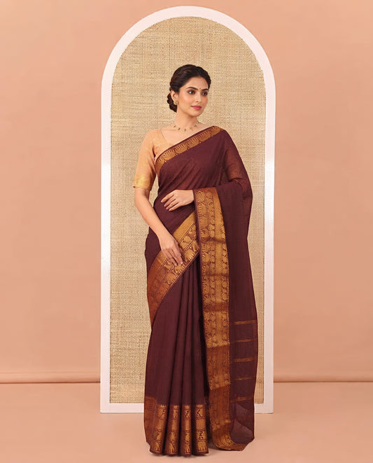 Coffee Brown Plain Sungudi Cotton Saree, Highlighted by Traditional Zari Border of Peacock and Elephant Motifs Weave, Subtly Striped Pallu, and Paired with a Contrast Veldhari Design Blouse