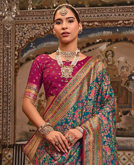 Blue Designer Saree, Impeccably Styled with Meenakari-Style Floral Designs All Over Its Body, Complemented by a Contrast Meenakari-Style Colorful Border, Intricately Designed Pallu, and Paired with a Contrast Blouse