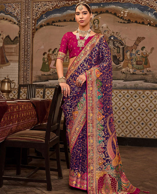Violet Designer Saree, Artfully Detailed with Floral Vine Designs All Over Its Body, Complemented by a Contrast Border of Peacock and Mughal-Style Human Motifs, Pallu of Meenakari-Style Mughal Designs, and Paired with a Contrast Blouse