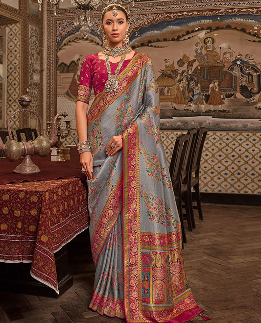 Grey Designer Saree, Gracefully Embellished with Meenakari-Style Floral-Bird Designs All Over Its Body, Complemented by a Contrast Floral Creeper Design Border,  Mughal-Style Designed Pallu, and Paired with a Contrast Blouse
