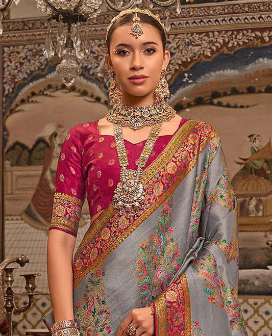 Grey Designer Saree, Gracefully Embellished with Meenakari-Style Floral-Bird Designs All Over Its Body, Complemented by a Contrast Floral Creeper Design Border,  Mughal-Style Designed Pallu, and Paired with a Contrast Blouse