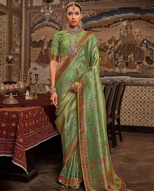 Green Designer Saree, Dazzled with Meenakari-Style Designs All Over Its Body, Complemented by a Contrast Mughal-Style Border, Opulently Embellished Pallu, and Paired with a Matching Blouse