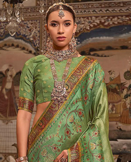 Green Designer Saree, Dazzled with Meenakari-Style Designs All Over Its Body, Complemented by a Contrast Mughal-Style Border, Opulently Embellished Pallu, and Paired with a Matching Blouse