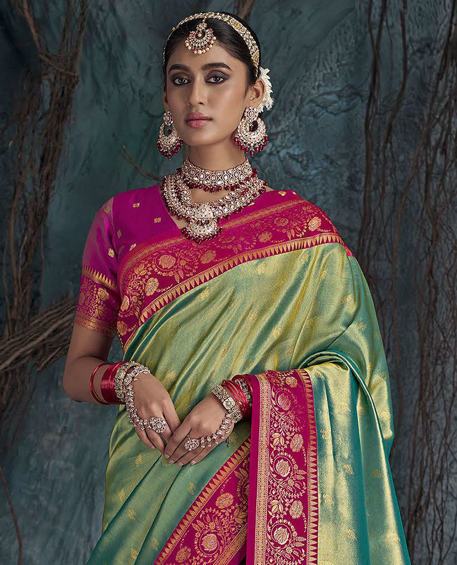 Green Designer Saree, Subtly Sparkled with Buttas All Over Its Body, Complemented by a Contrast Floral Creeper Border, Pallu of Intricate Designs, and Paired with a Contrast Blouse