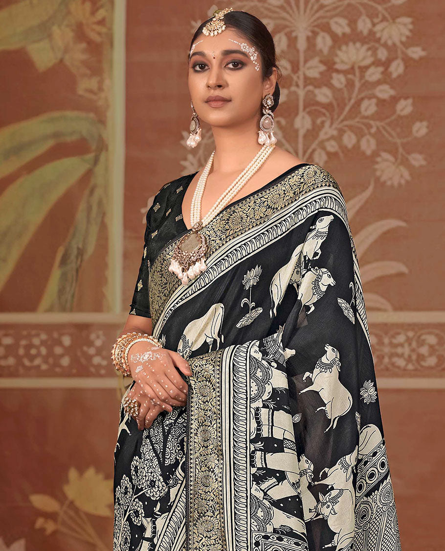 Black lotus and Pichwai cow printed designer saree, floral creeper zari border, and zari striped pallu