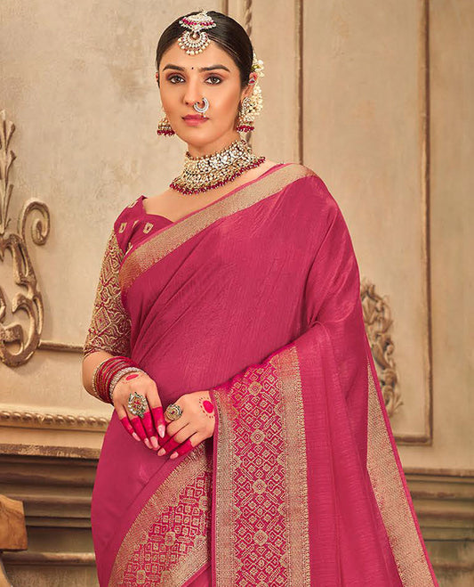 Pink plain designer saree, patola-style motifs woven border, and zari striped pallu