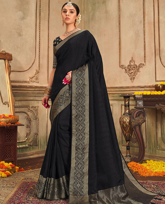 Black plain designer saree, patola-style motifs woven border, and zari striped pallu