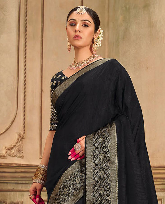 Black plain designer saree, patola-style motifs woven border, and zari striped pallu