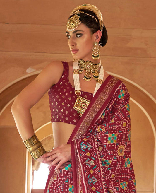 Burgundy double-ikkat patola printed designer catalog saree, stone work border, and patola patterned pallu