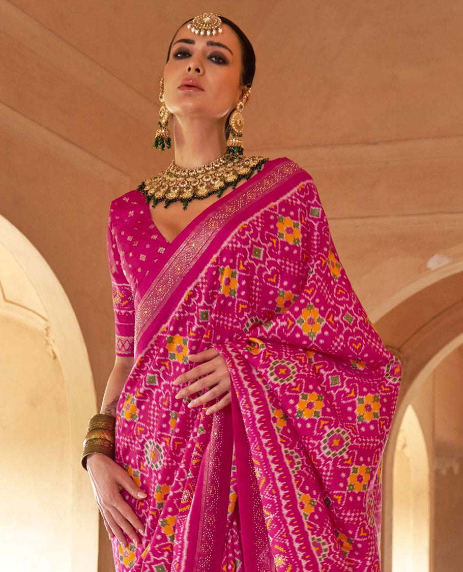 Rani pink double-ikkat patola printed designer catalog saree, stone work border, and patola patterned pallu