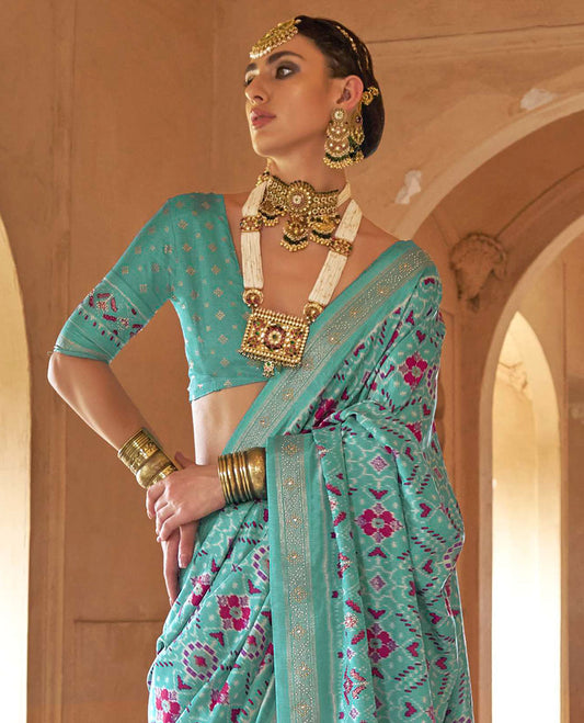 Turquoise double-ikkat patola printed designer catalog saree, stone work border, and patola patterned pallu