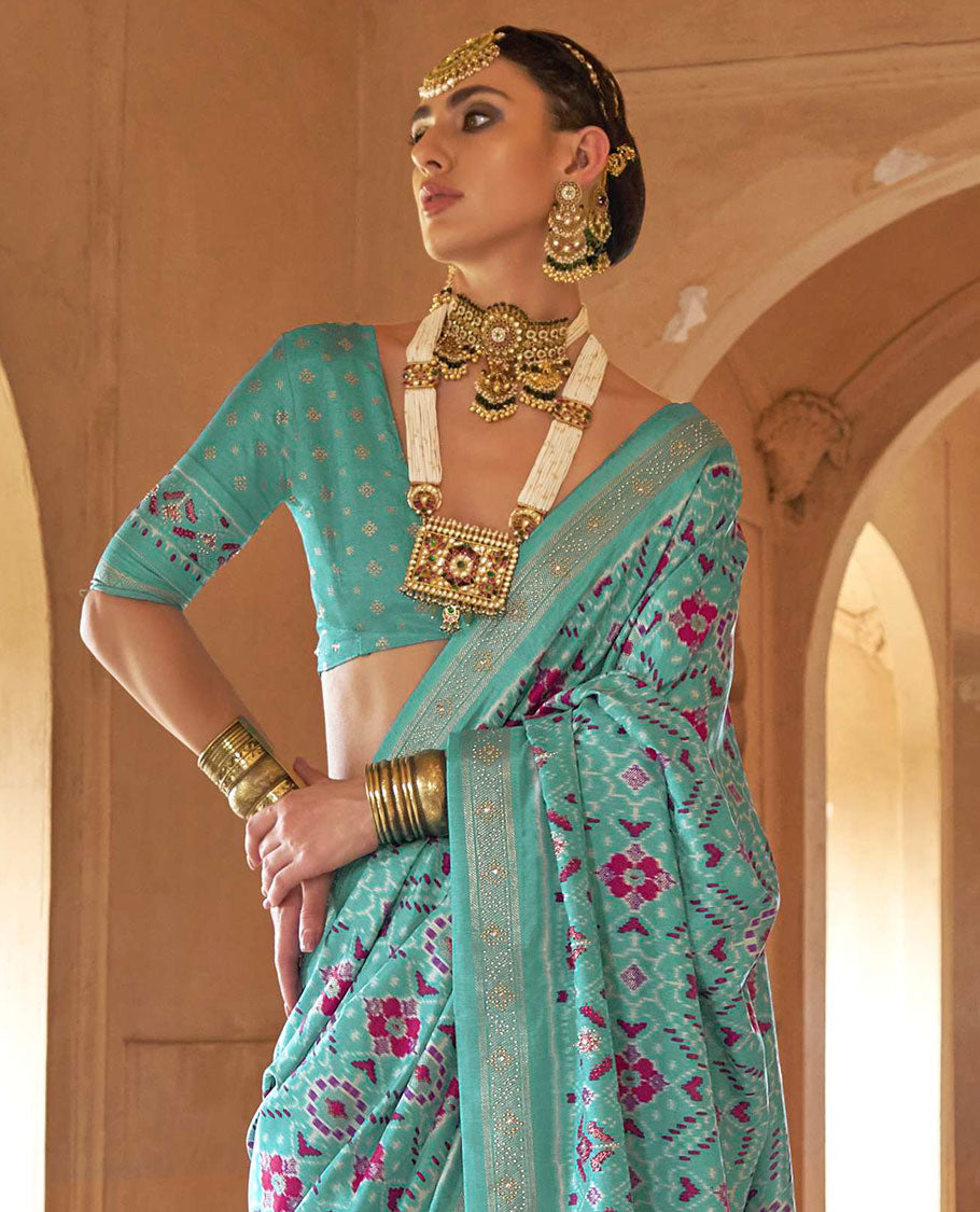 Turquoise double-ikkat patola printed designer catalog saree, stone work border, and patola patterned pallu