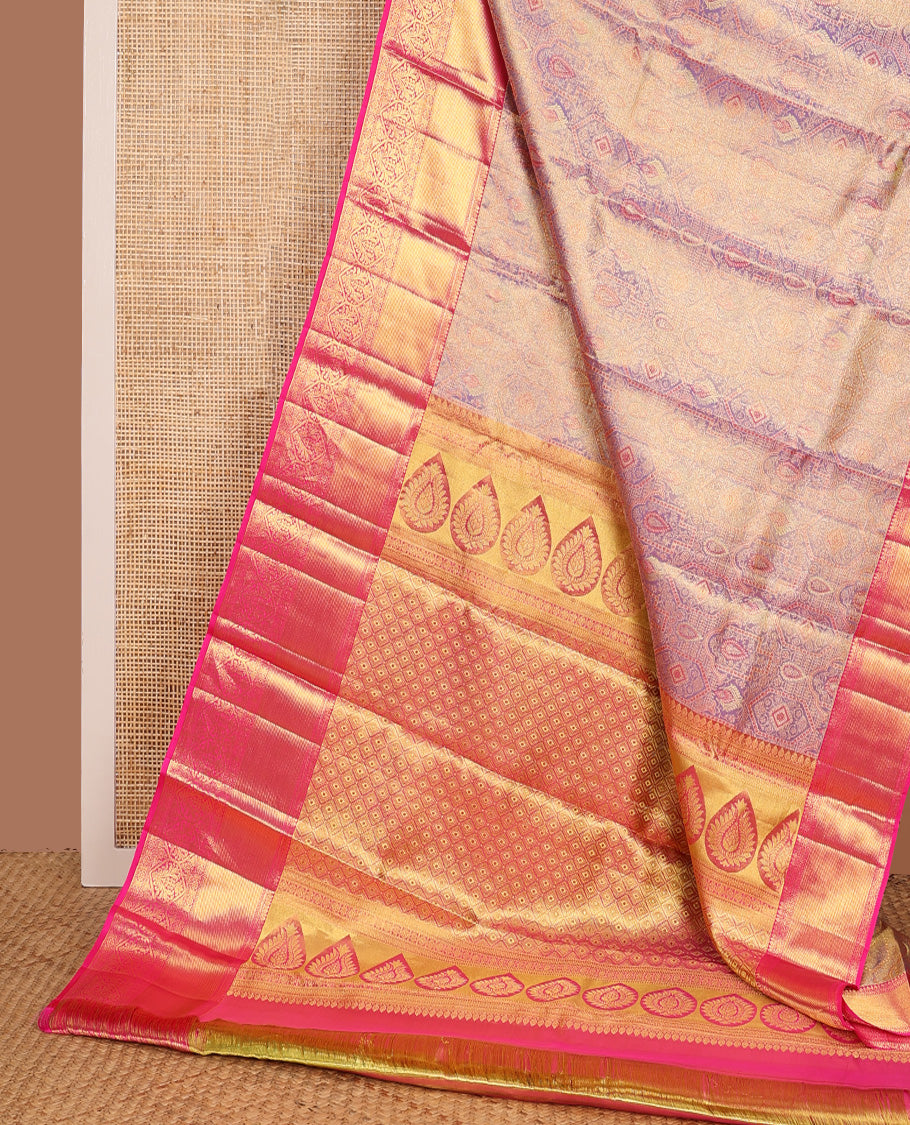 Gleaming lavender zari jacquard Kanchipuram tissue silk saree, contrast border of thilakam, kathir, muthu, kaddu kamalam, and Mughal-style floral bouquets, and jaal pallu