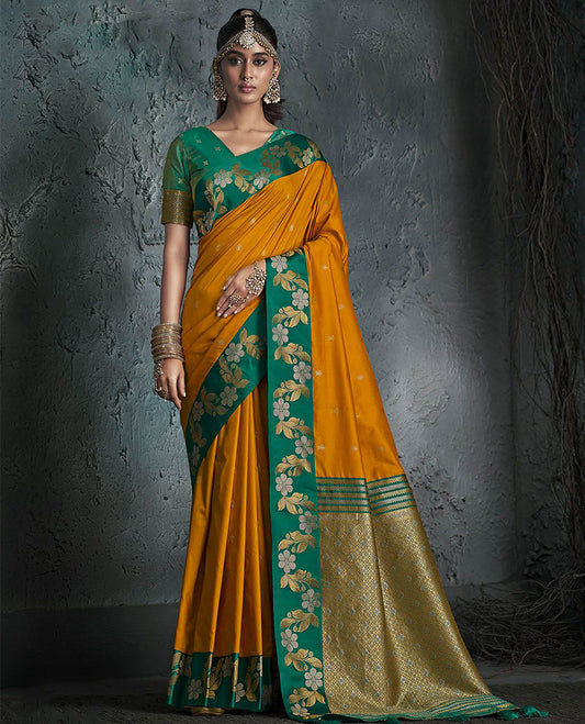 Orange Designer Saree, Featuring Buttas on Its Body, Complemented by a Contrast Border of Floral Creeper Designs, Pallu of Intricate Zari Designs, and Paired with a Contrast Blouse