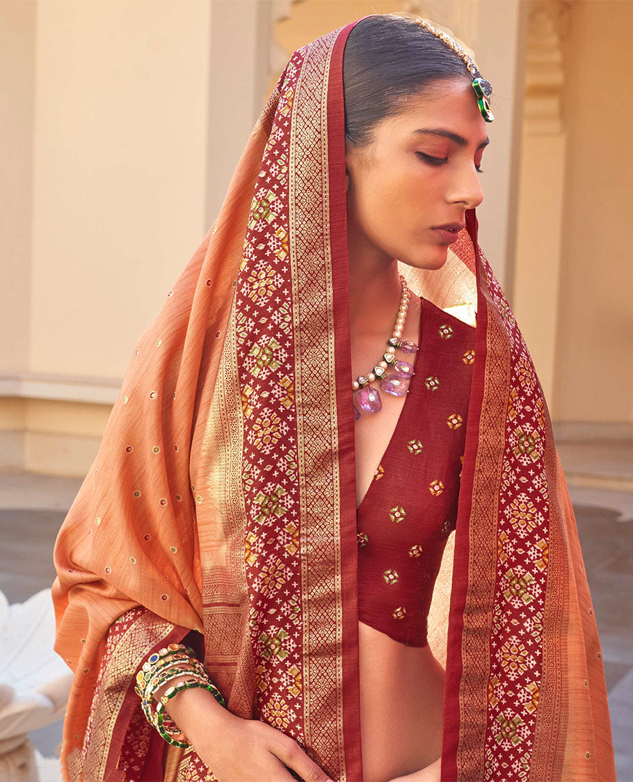 Orange Ikat Patola Designer Saree, Subtly Woven with Ikat Buttas, Complemented by a Contrast Ikat Border, Intricate Pallu, and a Contrast Blouse