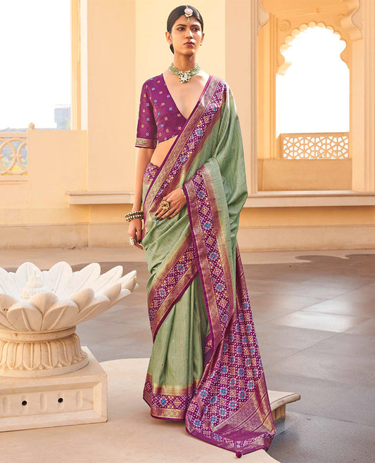 Pista Green Ikat Patola Designer Saree, Subtly Woven with Ikat Buttas, Complemented by a Contrast Ikat Border, Intricate Pallu, and a Contrast Blouse