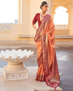 Orange Ikat Patola Designer Saree, Subtly Woven with Ikat Buttas, Complemented by a Contrast Ikat Border, Intricate Pallu, and a Contrast Blouse