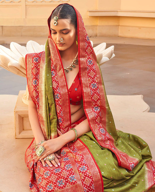 Green Ikat Patola Designer Saree, Subtly Adorned with Ikat Buttas, Complemented by a Contrast Ikat Border, Intricate Pallu, and a Contrast Blouse
