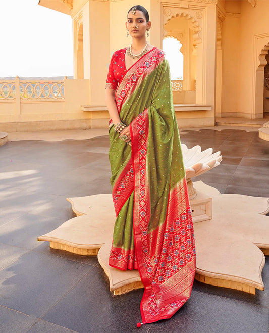 Green Ikat Patola Designer Saree, Subtly Adorned with Ikat Buttas, Complemented by a Contrast Ikat Border, Intricate Pallu, and a Contrast Blouse