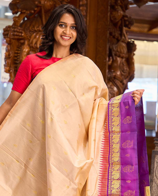 Sandal zari buttas Kanchipuram silk saree, contrast one-sided thazampoo rekku border of thilakam mokku and mayil zari motifs, and zari woven pallu