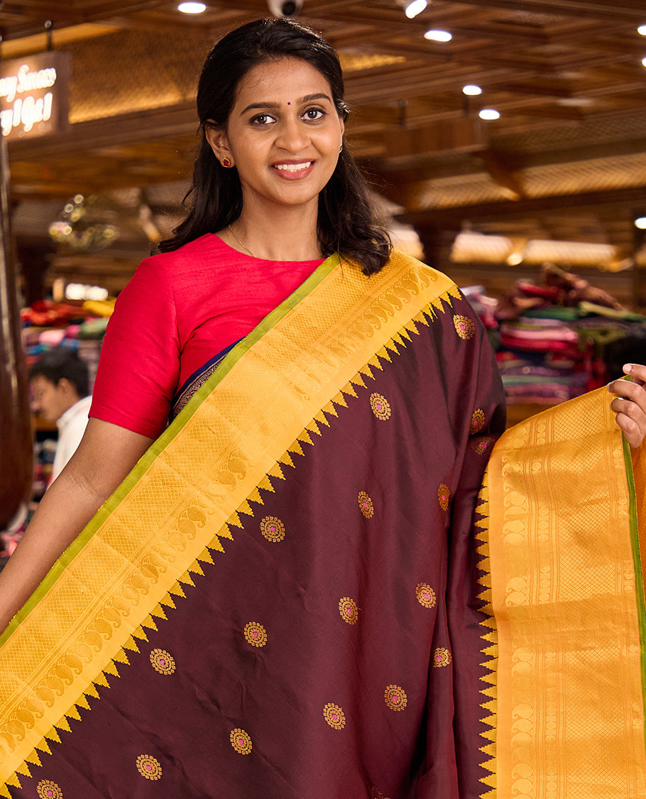 Maroon meena chakram buttas gadwal silk saree, contrast thazampoo rekku border of manga mokku, kathir, laddu kamalam, and mayil kann designs