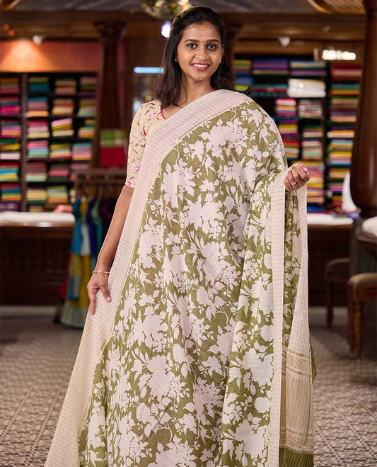 Light olive green silhouettes floral printed Muga silk saree, contrast temple zari checked border, and zari striped pallu