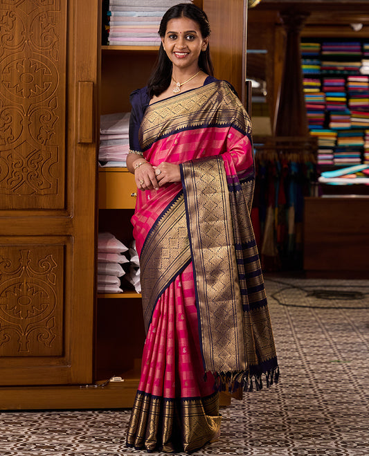 Pink zari buttas and checked Kanchipuram silk saree, contrast border of thazampoo rekku, kathir, mayil kann, and jaal designs
