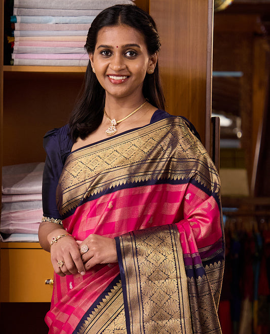 Pink zari buttas and checked Kanchipuram silk saree, contrast border of thazampoo rekku, kathir, mayil kann, and jaal designs