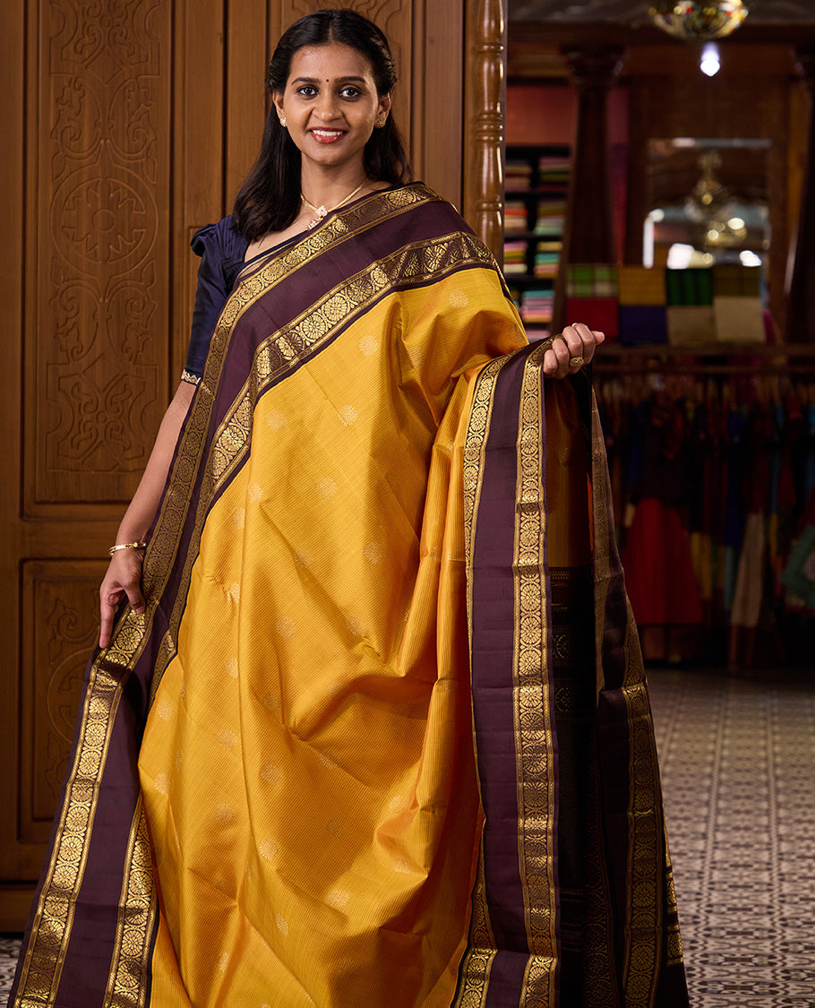 Mustard striped with chakram motifs Kanchipuram silk saree, contrast rettai pettu zari border of kathir, and poo chakram designs