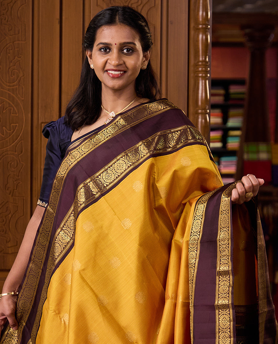 Mustard striped with chakram motifs Kanchipuram silk saree, contrast rettai pettu zari border of kathir, and poo chakram designs
