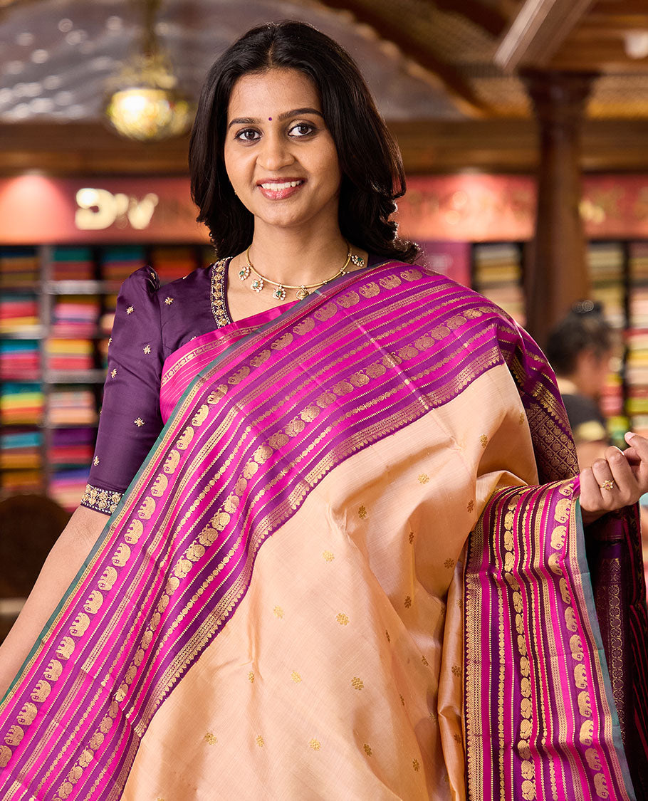 Sandal zari buttas Kanchipuram silksaree, contrast border of thilakam, muthu, laddu kamalam, mayil, and yaanai designs, and butta enclosed checked pallu